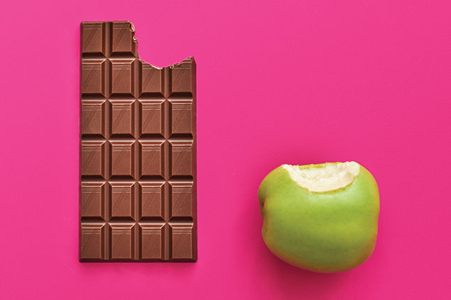 A bite out of a green apple and in a chocolate bar.