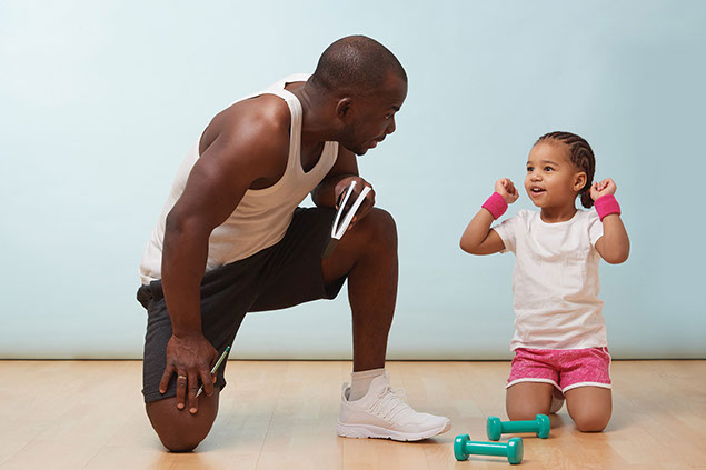 Father and young daughter about to exercise.