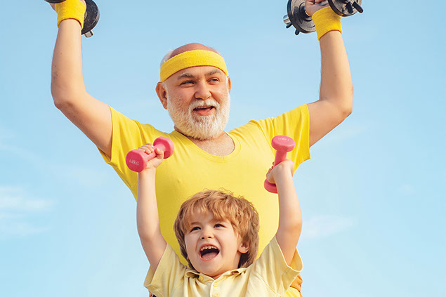 Grandfather and grandson exercising by lifting weights.