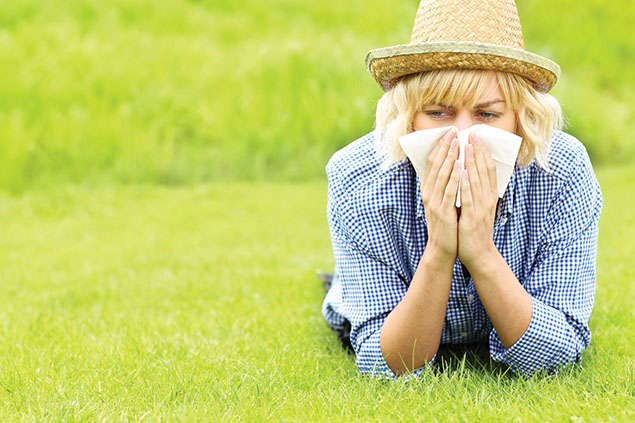 Women outside blowing her nose.
