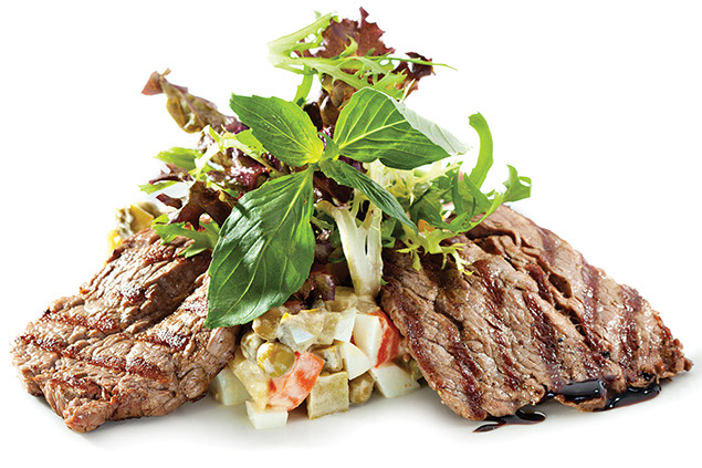 Two pieces of beef with garnish.