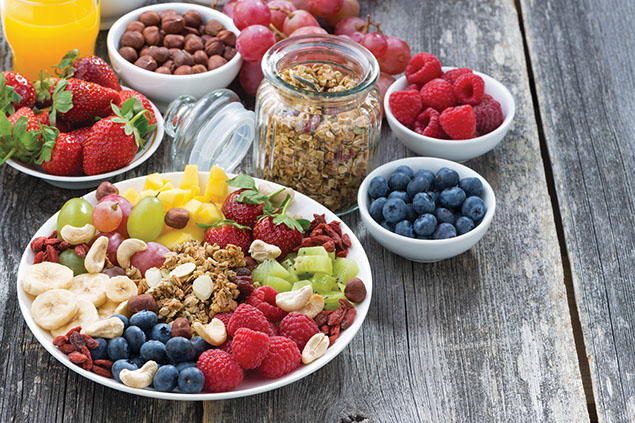 Dishes filled with berries, nuts and fruits.