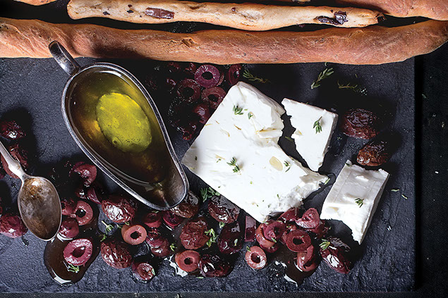 Olive oil, black oils, bread and cheese.