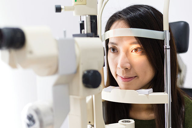 Female getting her eyes examied.