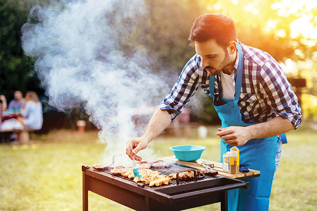 Man grilling food outside.