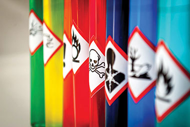 Image of posion cans with warning labels.