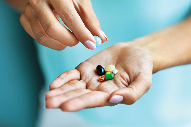 Close up image of hand with supplements.