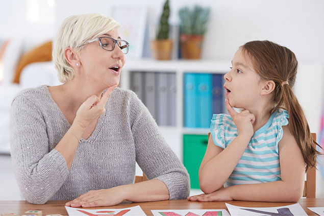 Adult helping child with speech.