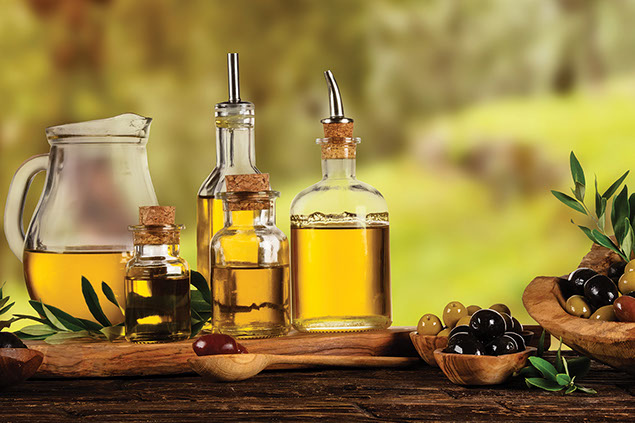 Olive oil bottles on table.
