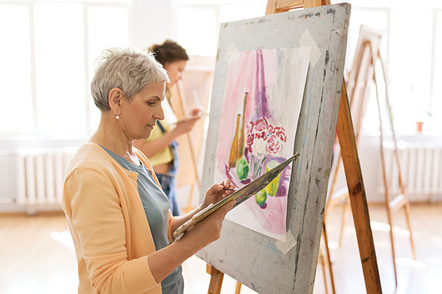 Elderly female painting.