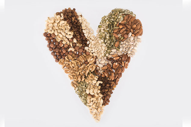 Variety of nuts shaped into a heart.