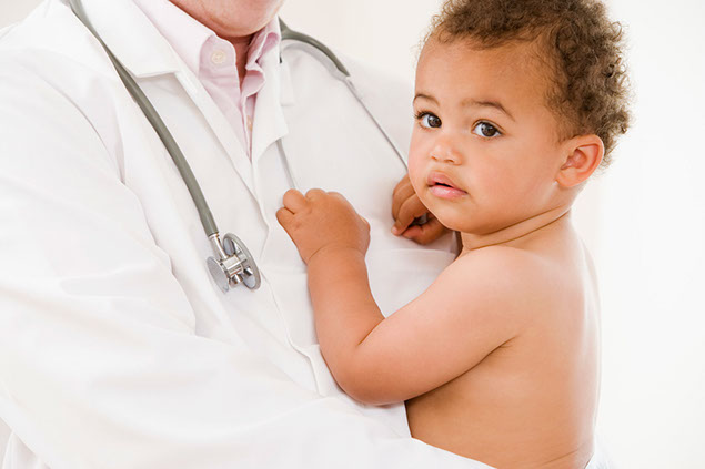 Image of doctor holding young child.
