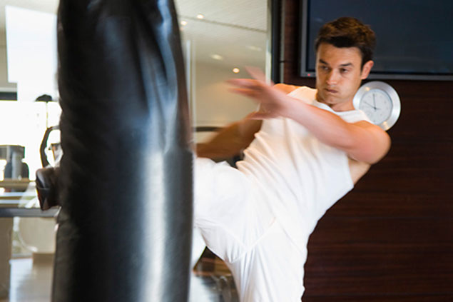 Image of young man kickboxing.