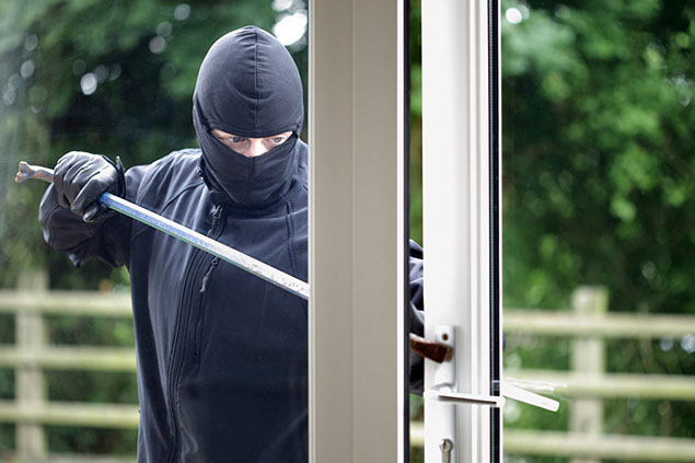 Image of man trying to break into home.