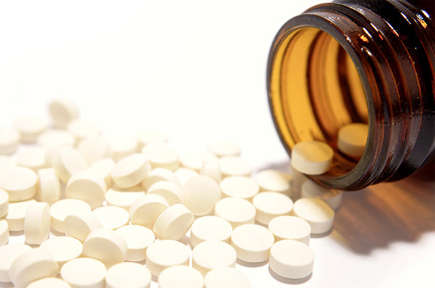 Image of a pill bottle with pills spilled out.