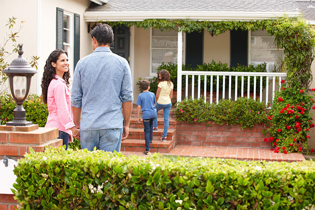 Image of family outside their home.