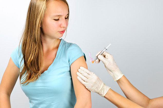 Image of young girl getting immunizations.