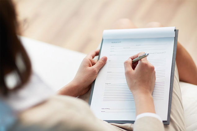 Image of person filling out forms.