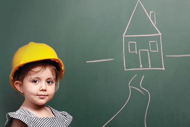 Image of child with a hard hat on an a drawing of a house.
