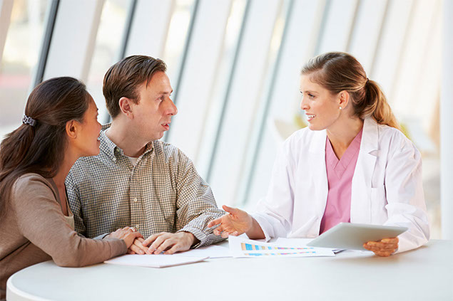 Image of doctor talking to couple.