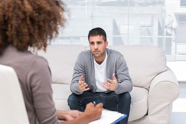 Image of a man at a therapist session.