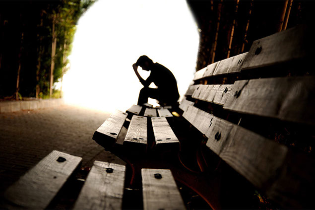 Image of person sitting alone on bench.