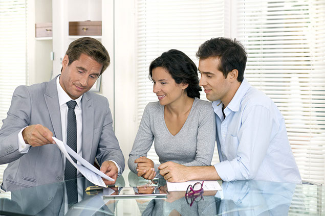 Image of couple talking to insurance agent.