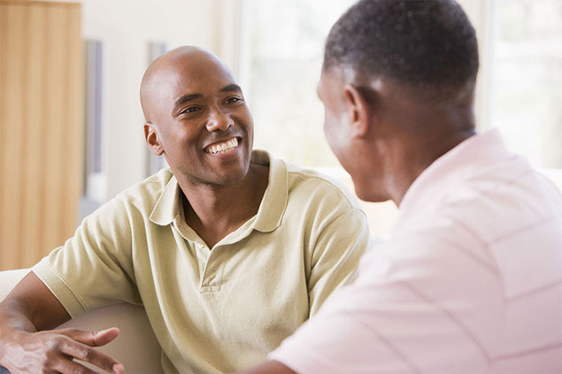 Image of two men talking.