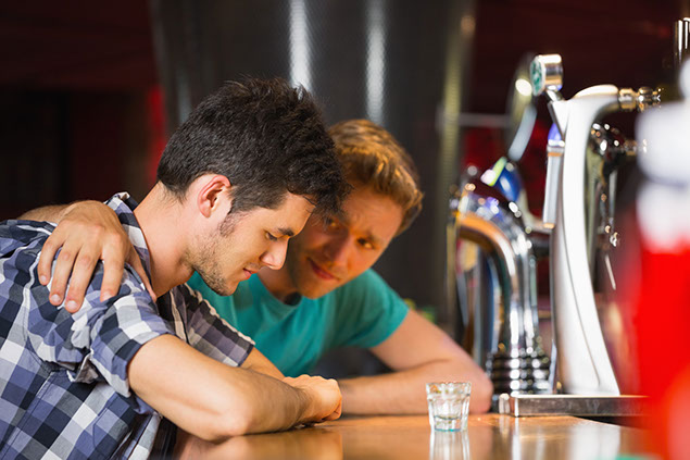 Image of 2 friends at a bar.