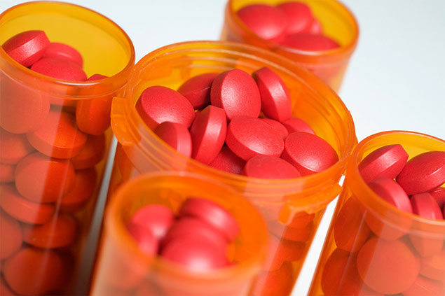Image of medications in pill bottles.