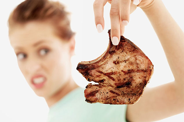 Image of women throwing out old food.