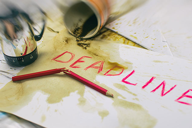 Image of coffee spilled over paper with word "Deadline".