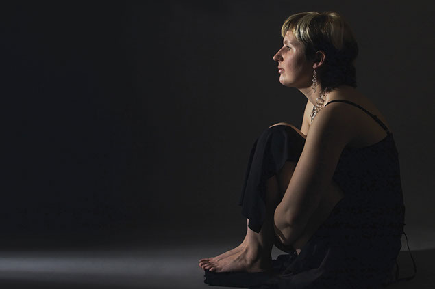 Image of person sitting in the dark.