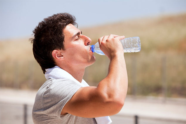 Image of man drinking water.