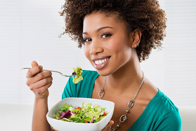 Image of women eating a healthy salad.
