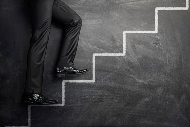 Concept image of stairs drawn in chalk with person climbing up.