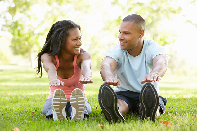 Image of young couple stretching.