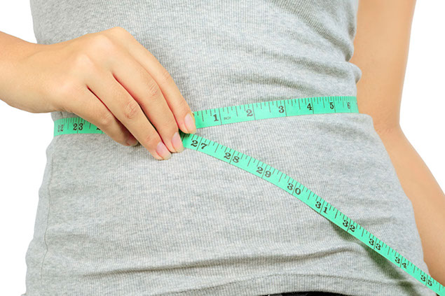 Image of female measuring waist.