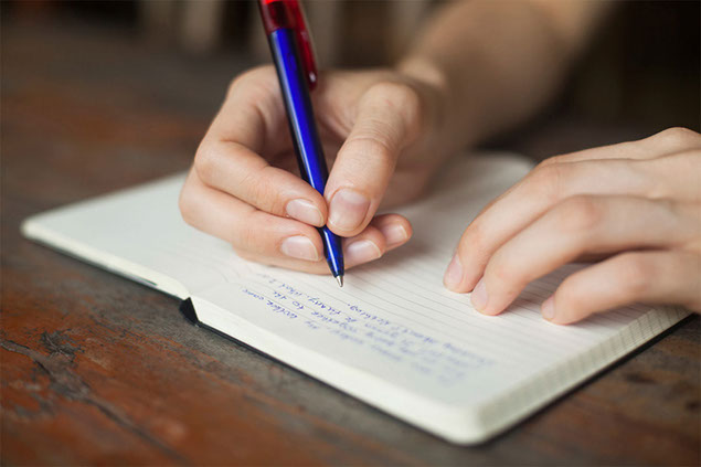 Close up image of hand writing on paper.