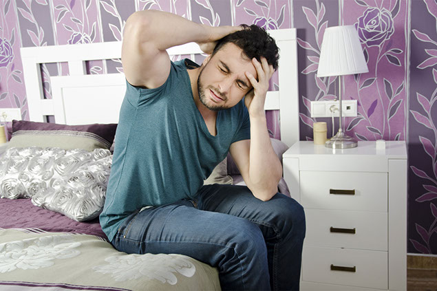 Image of man suffering a hangover.