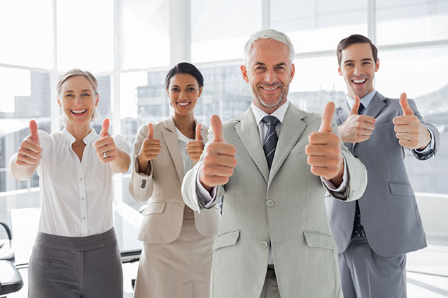 Image of employees with thumbs up.