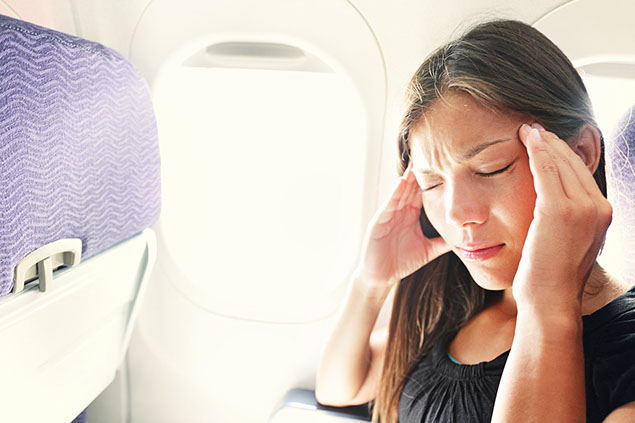 Women on a plane suffering motion sickness.