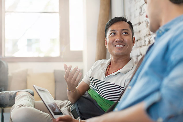 Image of two adult friends talking to each other.