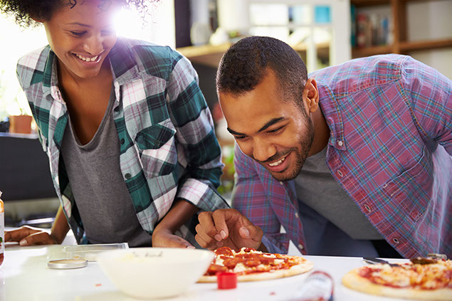 Image of young couple cooking.