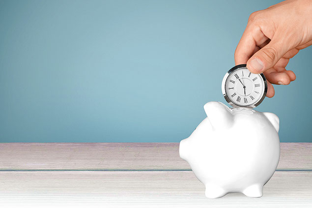 Image of small circle clock going into piggy bank.