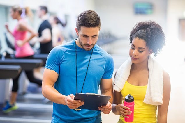 Image of women talking to her fitness trainer.