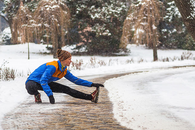 Image of person streching outside in winter.