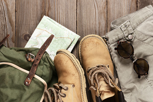 Image of hiking boots, backpack and map.