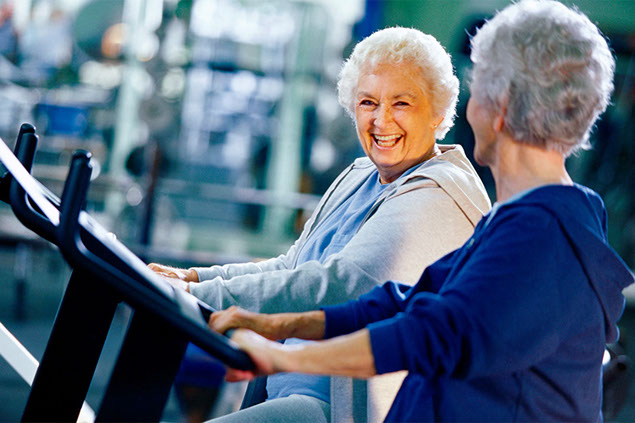 Image of 2 older women walking on treadmills.