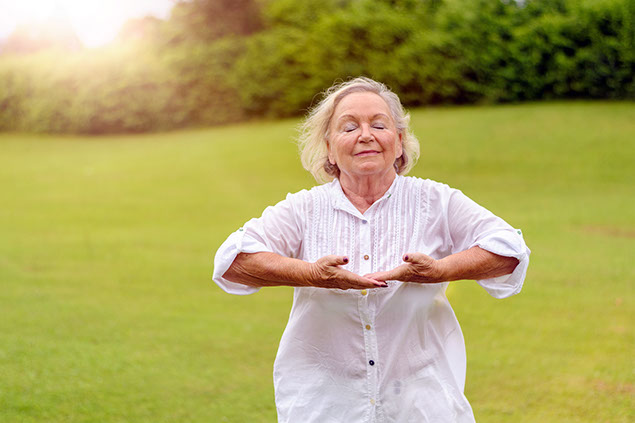 Image of older women doing breathing exercises.